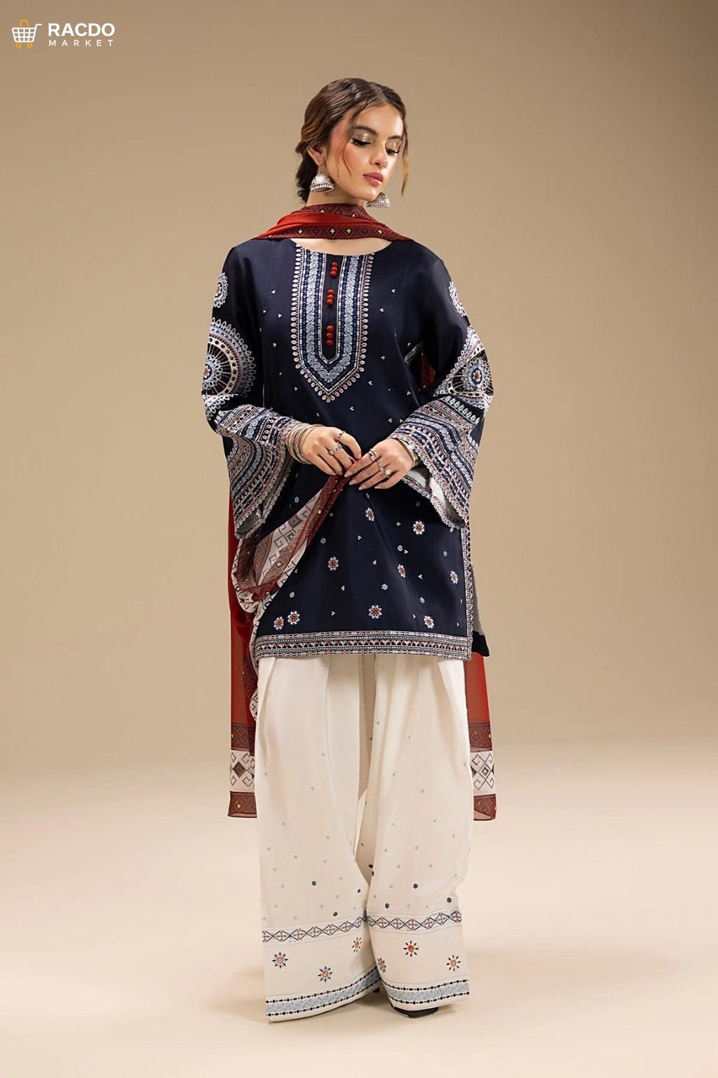 Woman wearing a navy blue embroidered top and white pants with a red dupatta on a beige background

 