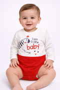Baby wearing a white and red onesie with text on a white background

