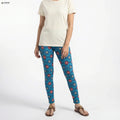 Person wearing blue patterned leggings and a white shirt on a white background